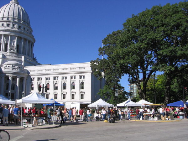 a white building with persony tents