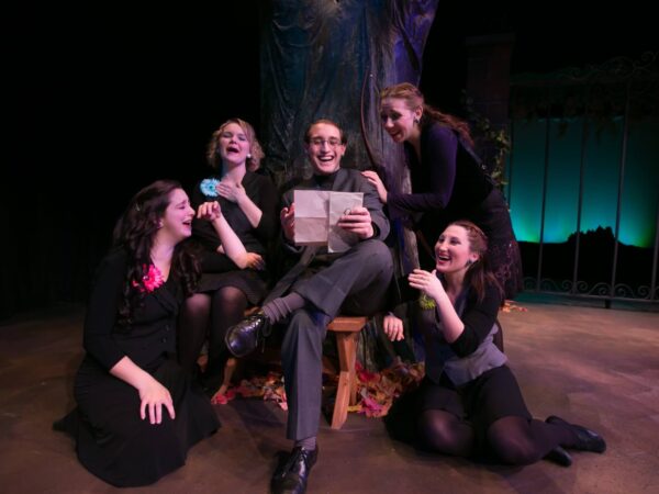 a group of women sitting on a stage