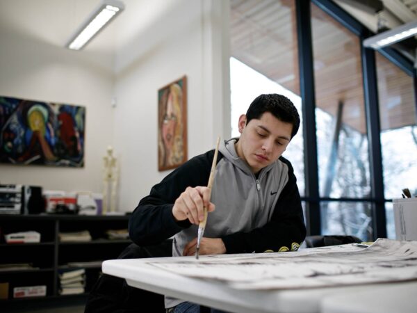 a person painting on a paper