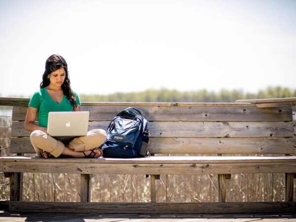 student on a laptop outside