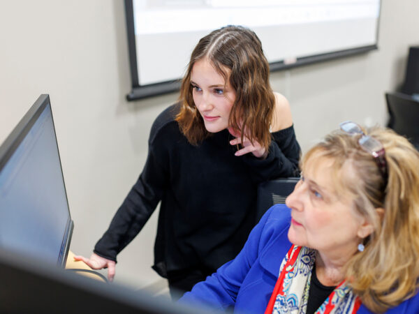 two women looking at a computer monitor