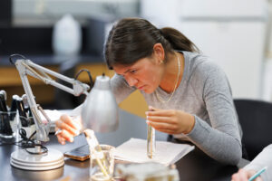 student looking under a microscope