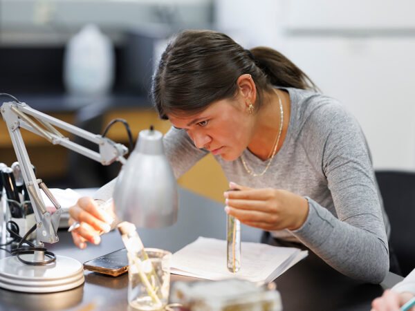 student looking under a microscope