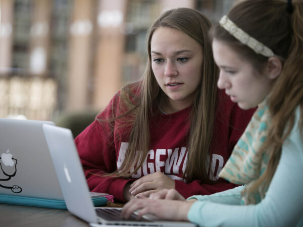 two students looking at a monitor