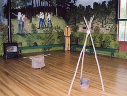 a wooden floor with a teepee and a bucket